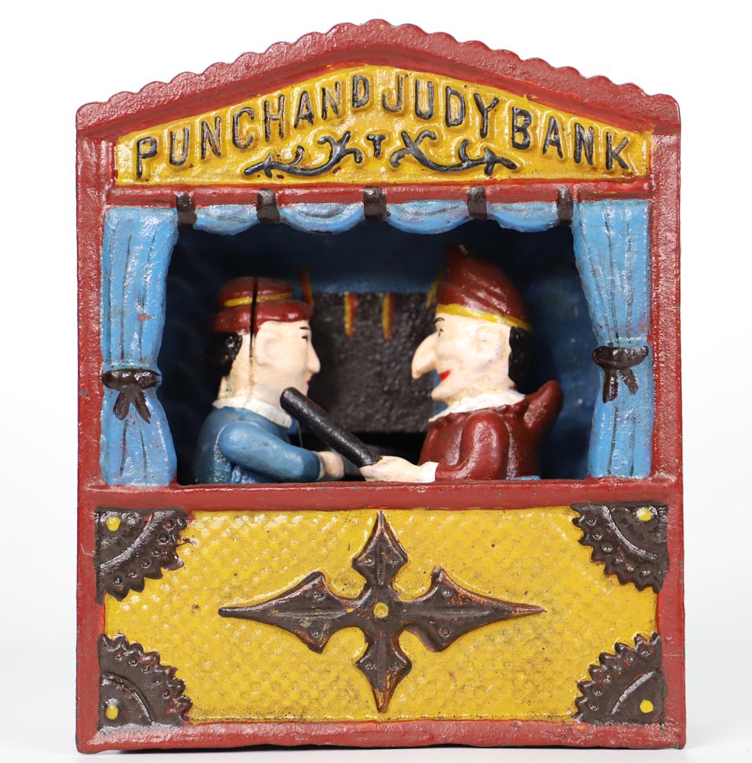 Cast Iron Coin Bank: Vintage Punch and Judy cast iron coin bank; Marked "Reproduction from The Book Of Knowledge"; Measures approximately H 7 x W 6 x D 4 inches; Working condition unknown. See photos