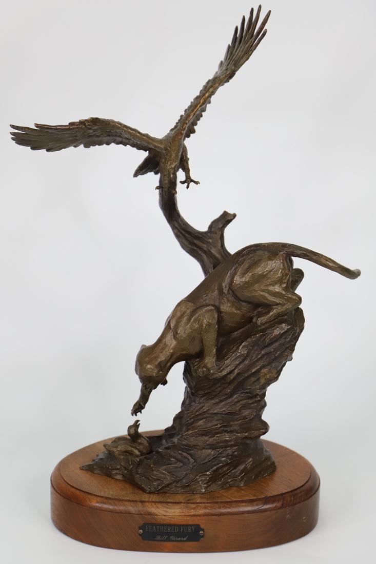 Bill Girard, Bronze Sculpture: Bronze sculpture titled "Feathered Fury"; Artist signature and number 9/25 on back; Sculpture is mounted on a wooden stand that has a plaque with sculpture title and artist name; Measures approximatel