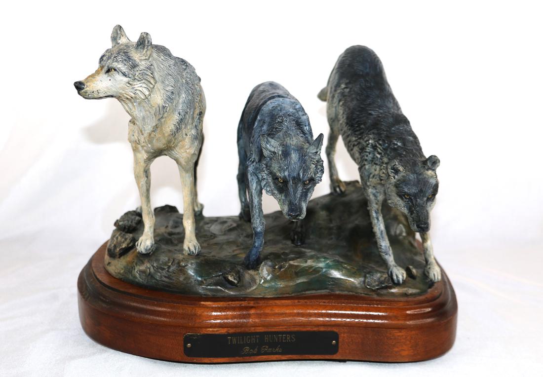 Bob Parks, Bronze Sculpture: Bronze sculpture titled "Twilight Hunters"; Artist signature and number 15/30 on base; Sculpture is mounted on a wooden swivel stand that has a plaque with sculpture title and artist name; Measures ap