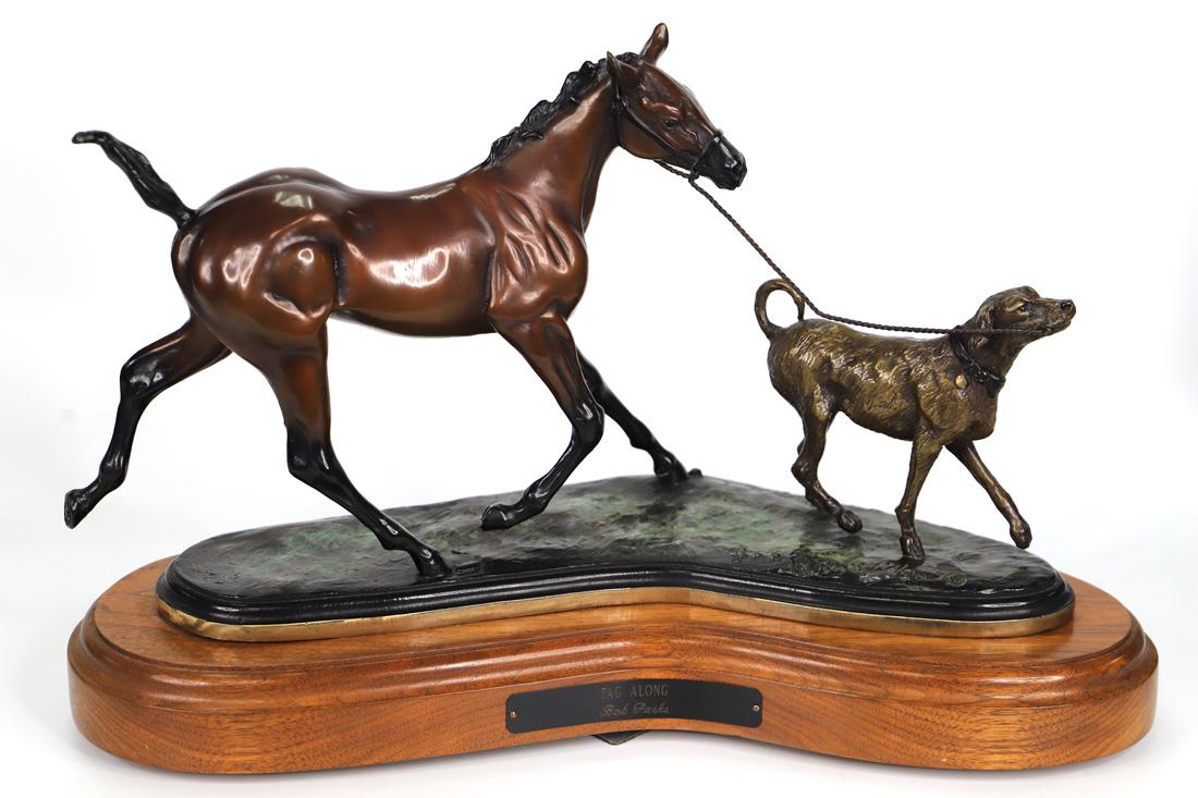 Bob Parks, Bronze Sculpture: Bronze sculpture titled "Tag Along"; Artist signature and number 17/30 on base; Sculpture is mounted on a wooden swivel stand that has a plaque with sculpture title and artist name; Measures approxima