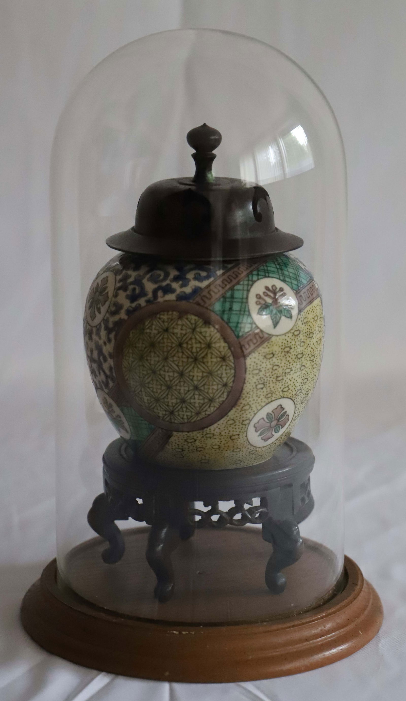 Yishidariya, Xutani Design Jar: Hand painted Yishidariya Kutani Design jar with wood lid; Sits on a wood stand; Glass cloche with wood base fits the jar; Jar with lid stands H 6 inches; No damage observed; See photos. Pick up in Den