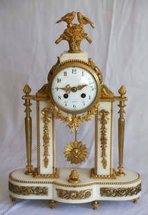 French Marble Mantel Clock: White marble with ormolu embellishments; Marked "Paris" on the porcelain face; Working condition unknown; Measures approximately H 17 x W 12 x D 5 inches; No key; Chips in marble; Hairline crack on