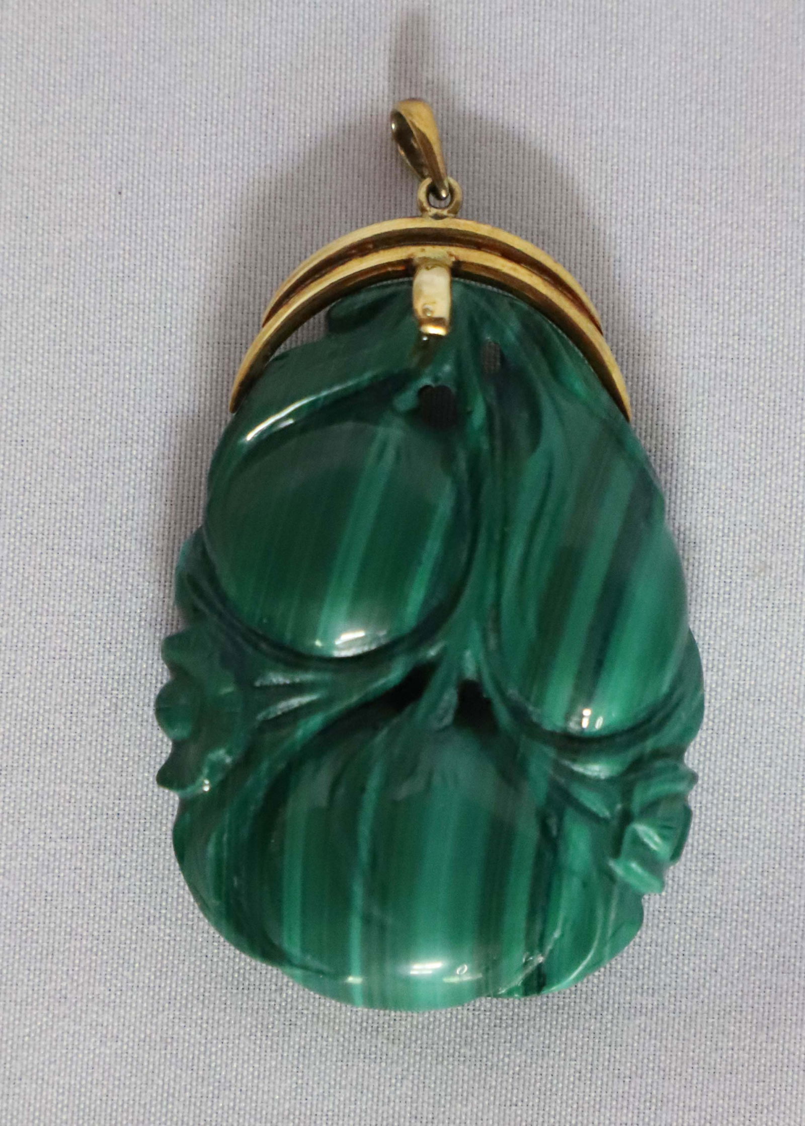 Malachite Pendant: Malachite pendant carved on both sides; With gold "585" clasp; Measures approximately H 2 x W 1/2 inches; No damage observed; See photos. Pick up in Denver