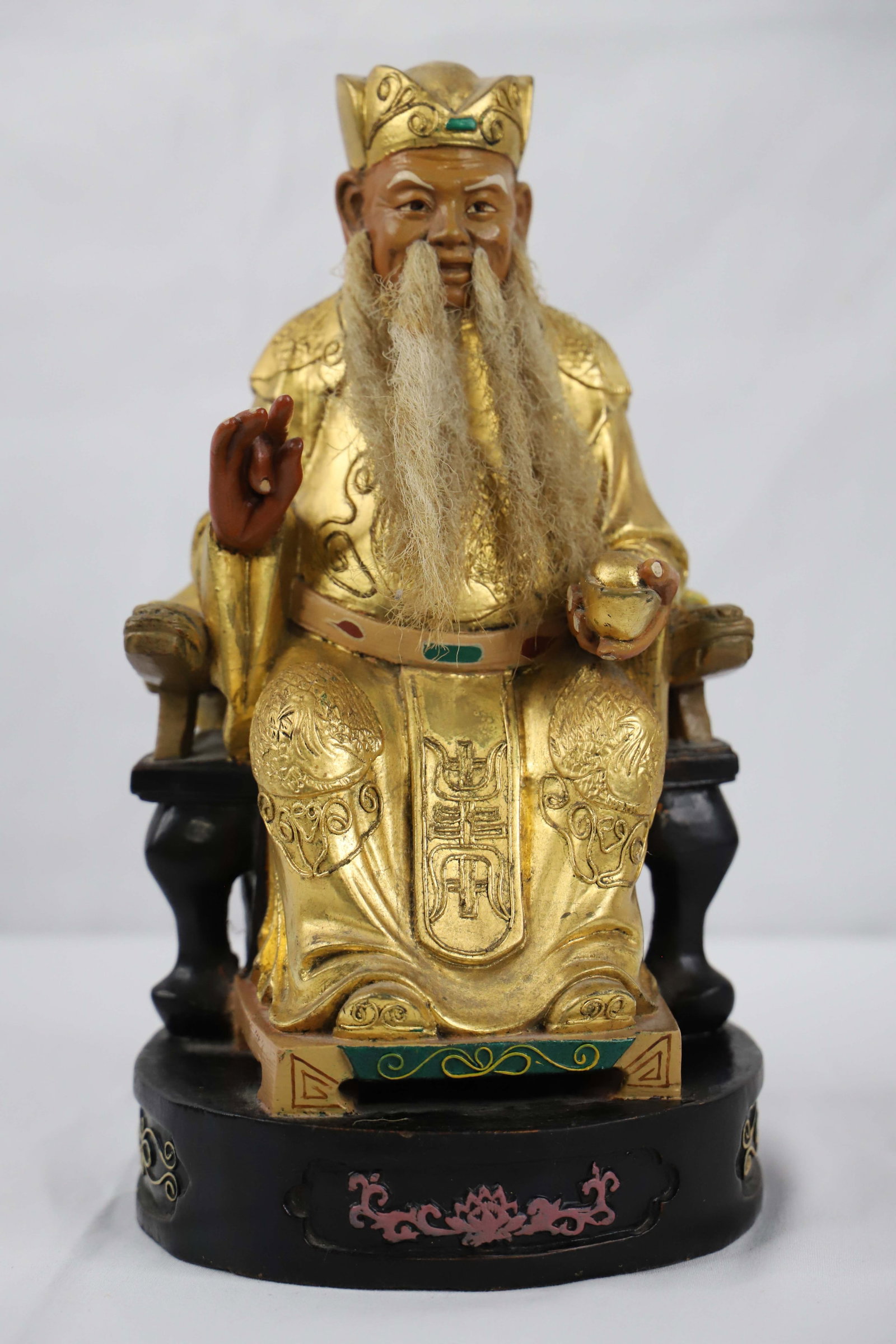 Asian Figurine: Painted and carved wood Asian figurine; No maker marks observed; Possibly real hair; Measures approximately H 10 x W 5 1/2 x D 5 inches; Back has dents; some scratches in paint; See photos. Pick up in