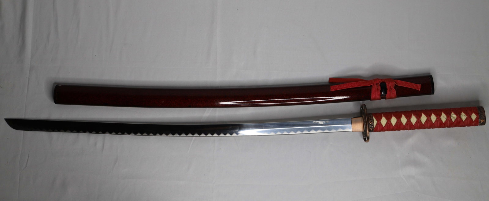 Metal Sword: Metal sheath and sword with stainless steel blade; Marked "Made in Taiwan; Measures approximately L 40 inches; Tarnishing on hilt; Metal sheath has some damage; See photos. Pick up in Denver