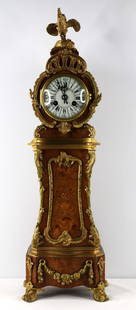 Vincenti & Cie; French Mantel Clock: Inlaid wood clock with ormolu detail and a rooster finial; Porcelain face; Face is marked "V. Depose"; Key is present; Maker mark has a date of 1855; Measures approximately H 21 1/4 x W 6 1/4 inches;