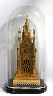 Raingo Freres, Cathedral Clock: Ormolu Cathedral clock; Marked "Raingo Freres, Paris"; Has two keys; Encased in large glass cloche; Measures approximately H 21 1/2 x W 8 1/4 x D 5 1/4 inches; Working condition unknown; Rubs and mark