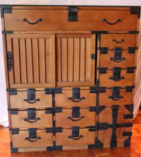 Tansu Merchant Chest: Japanese Tansu merchant chest; Possibly from the early 20th century; Chest is wood with metal hardware and metal top surface; Features thirteen locking drawers and three locking cabinet doors; Lower r