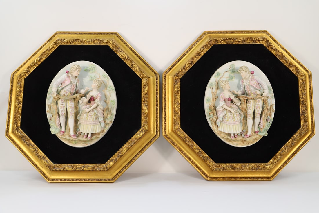 Vintage Bisque Wall Art: Two vintage porcelain bisque reliefs of courting couples; Both are mounted on velvet in gold frames; No maker marks observed; The bisque sculptures measure approximately H 13 x W 10 x D 3 inches; No d