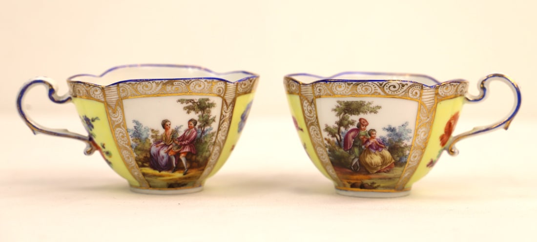 Meissen, Teacups: Two hand painted courting couple quatrefoil teacups; Meissen backstamp; Each measures approximately H 2 x W 4 1/4 x D 3 inches; Some wear to gilt paint around cup rims. See photos