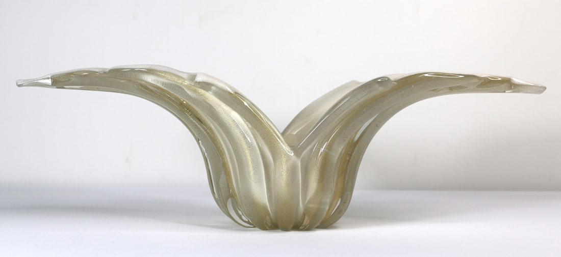 Murano Glass, Console Bowl: Murano style glass console bowl; Opaque cream colored glass with embedded gold colored flecks; No maker mark observed; Measures approximately H 5 1/2 x w 18 1/4 x D 5 inches; No damage observed. See p