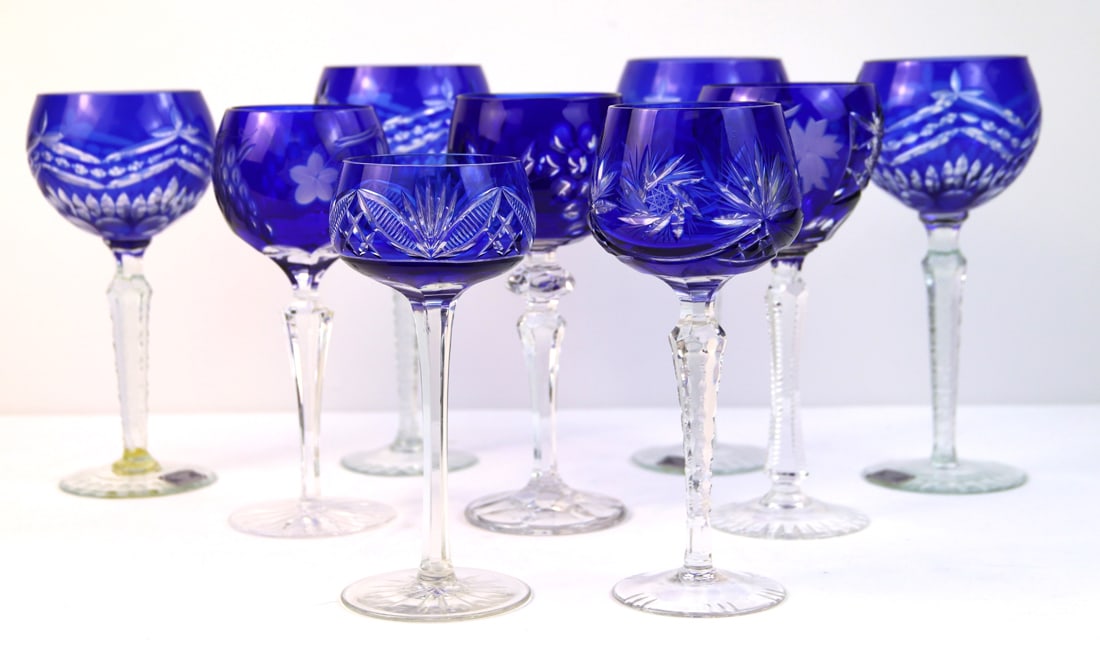Godinger, Crystal Wine Glasses: Four matching Godinger cut to clear cobalt wine glasses; Marked "Crystal Legends by Godinger Made in Romania" on the tag; Five glasses in mismatched patterns of blue cut to clear crystal; Godinger gla