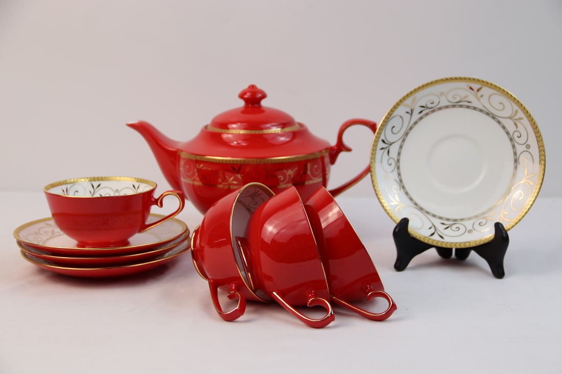 Teavana, Tea Service: Tea service includes four cups, four saucers, one teapot and original box; All are marked "Teavana Exclusive Collection Hand Finished Fine Bone China" on the back stamp; Teapot measures approximately 