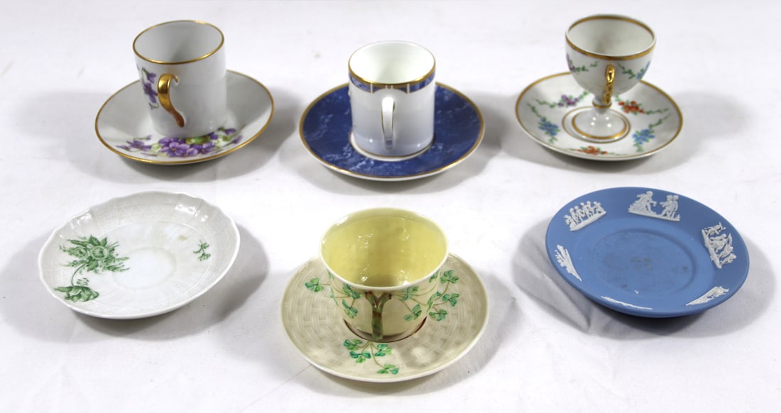 Wedgwood, Limoges, Dresden, Belleek, Cups/Saucers: Cups and saucers by various makers; Four sets of matching cups and saucers and two saucers with no cups; The blue and white with gold trim and stemmed floral are Wedgwood; The purple flowers are Limog