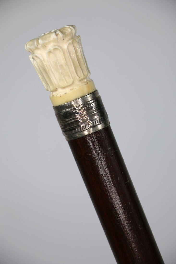 Bone Handled Cane: Antique bone handled walking stick / cane with hallmarked silver collar and horn ferrule; Measures approximately H 34 inches; Finish on wood shaft is chipped in places; Silver collar is tarnished. See