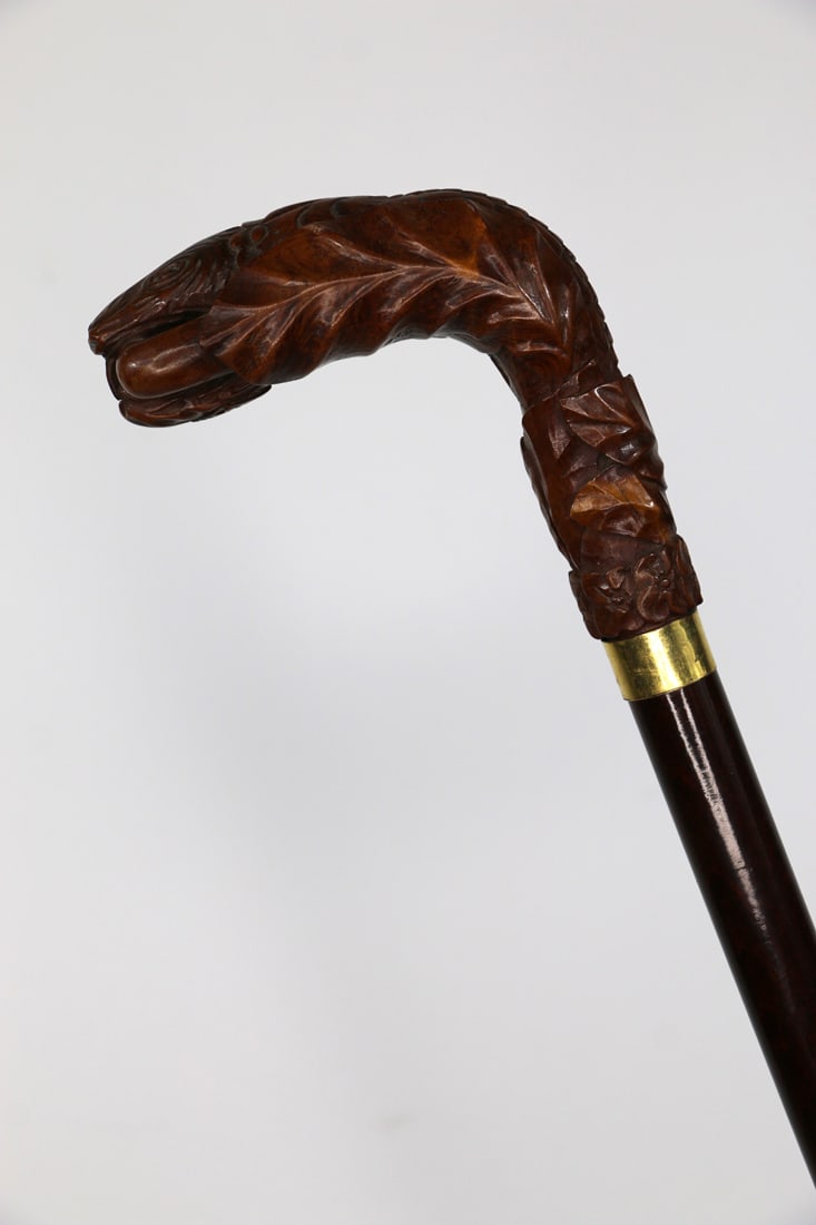 Carved Wooden Cane: Wooden walking stick / cane with handle carved into the form of a snake head, gold collar, wood shaft and bone ferrule; Measures approximately H 37 inches; No damage observed. See photos