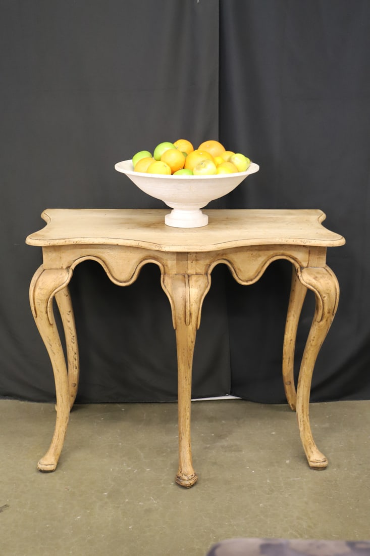 Table, Fruit Bowl: Wooden entry table; Pottery centerpiece bowl filled with faux fruit; No maker marks observed; Table measures approximately H 34 x W 40 x D 23 inches; Table top separates from base; Surface of table to