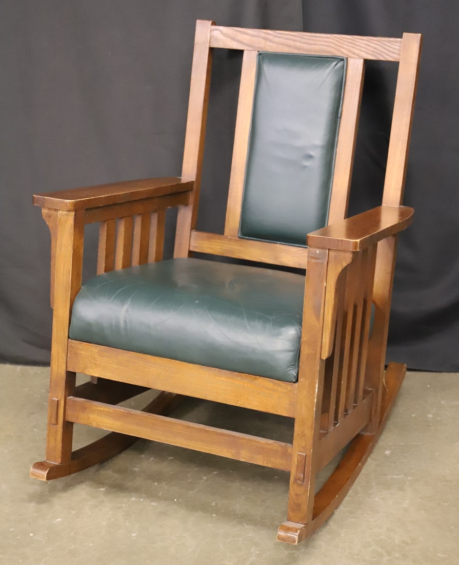 Rocking Chair: Arts and Crafts Mission-style rocking chair; Leather upholstered seat and chair back; No maker mark observed; Measures approximately H 37 x W 29 x D 33 inches; Chair is in used condition with scrapes 