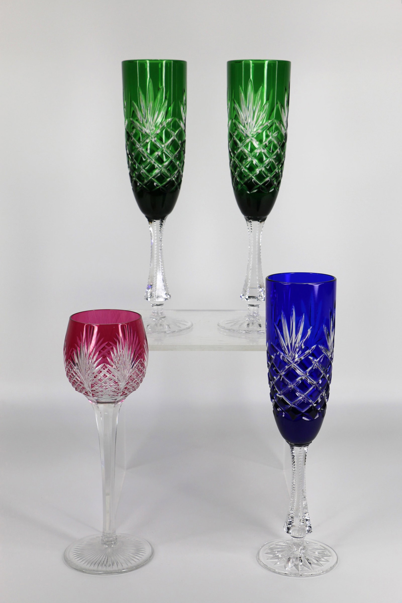 Faberge, Champagne Flutes: Three cut to clear champagne glasses and one wine glass; Flutes are marked "Faberges" on the base; No marks on the wine glass; Flutes measure approximately H 9 1/2 x Diameter 2 1/4 inches; No damage o