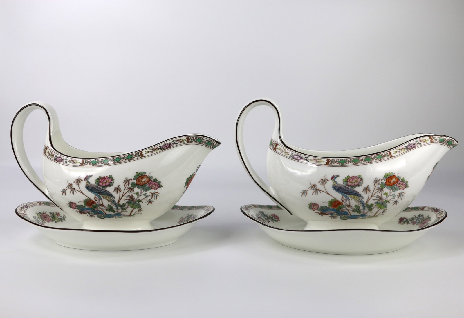 Wedgwood, Gravy Boats: Two gravy boats with unattached saucers/underplates; In the Kutani Crane pattern; Number R4464; With the underplate, one measures approximately H 6 x W 8 1/2 x D6 inches; In used condition but no dama