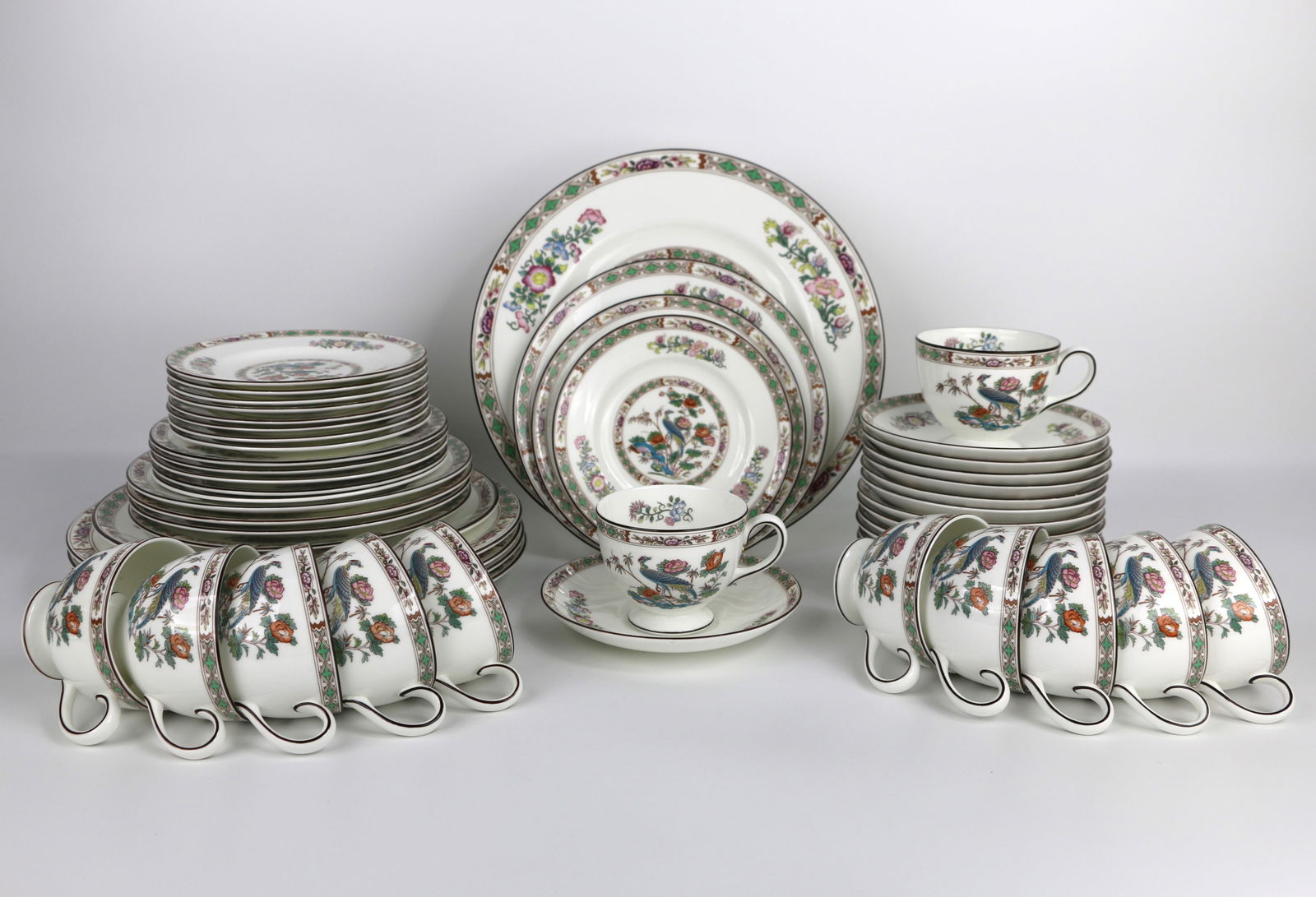 Wedgwood, Dinner Service: Forty-five mismatched place setting pieces; Lot includes five dinner plates; one luncheon plate; six dessert plates, nine bread /butter plates, twelve cups with saucers; In the Kutani Crane pattern; S