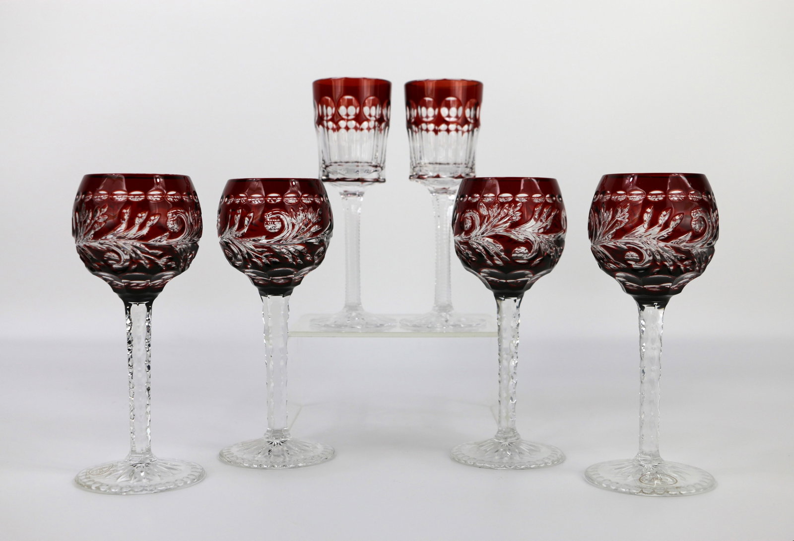 Ajka, Faberge, Ruby Glasses: Two crystal ruby liqueur / cordial glasses marked "Faberge" on the bottom; Four crystal ruby claret glasses; Each has a sticker on the base; Faberge glasses measure approximately H 5 3/4 x Diameter 1 