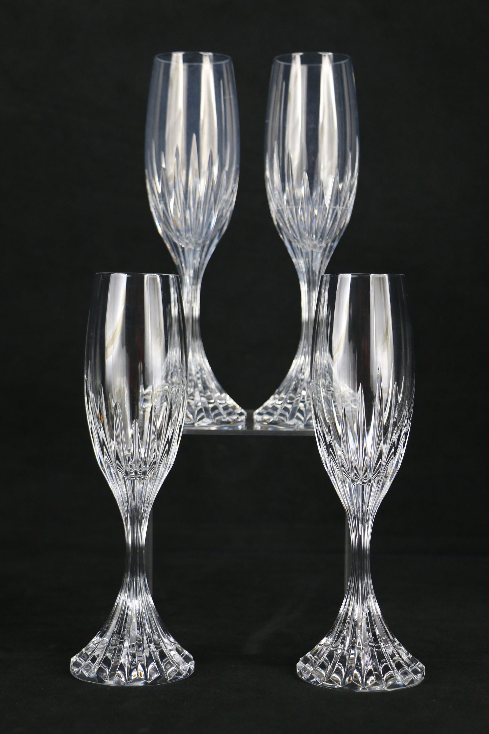 Baccarat Crystal, Champagne Flutes: Four crystal champagne glasses marked "Baccarat France" on the bottom; In the Massena pattern; Each glass stands approximately H 8 3/4 inches; Two glasses have rings inside the glass that appear to be