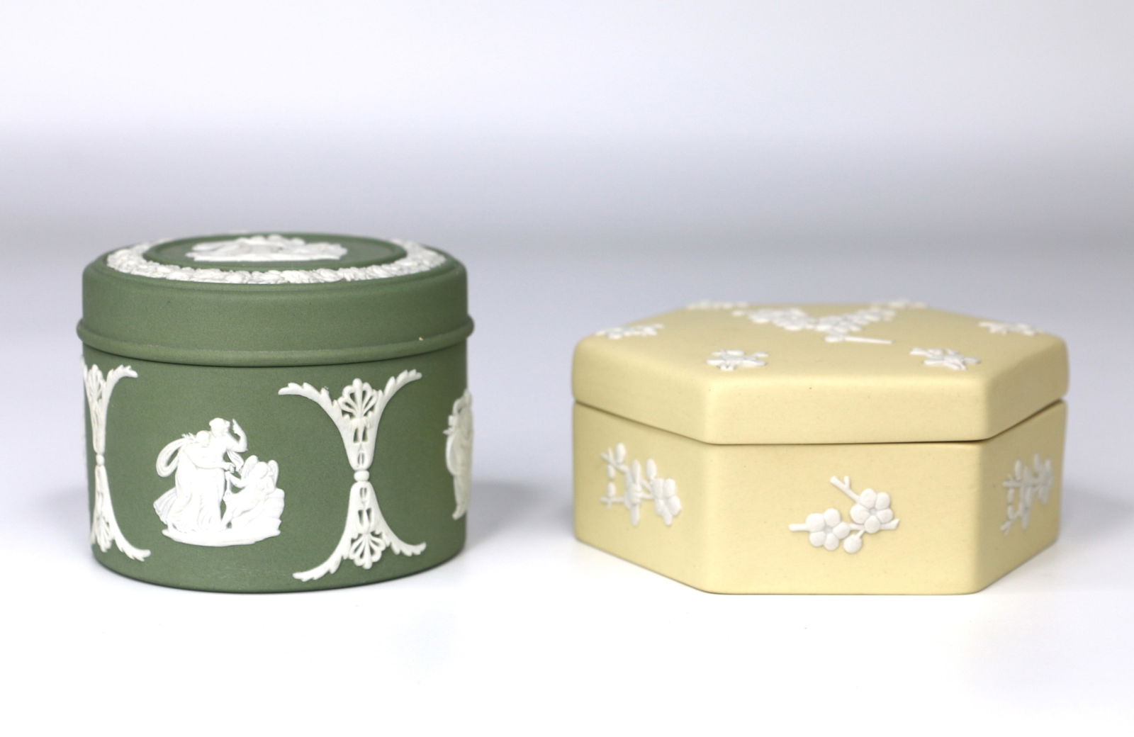 Wedgwood, Jasperware: Two trinket boxes in yellow and green; Both are marked "Wedgwood, England"; Tallest measures approximately H 2 x Diameter 2 3/4 inches; No damage observed. See photos