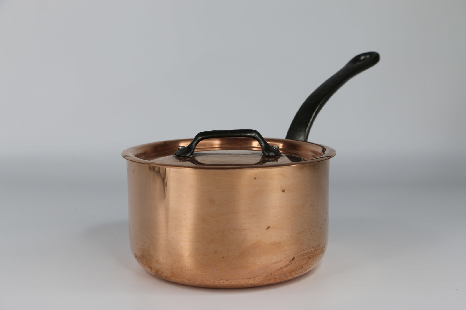 Mauviel, Copper Sauce Pan: Saucepan with lid; Manufacturers sticker inside pot; Measures approximately H 3 1/4 x Diameter 5 1/2 inches; Scratches on bottom and tarnishing on copper. See photos
