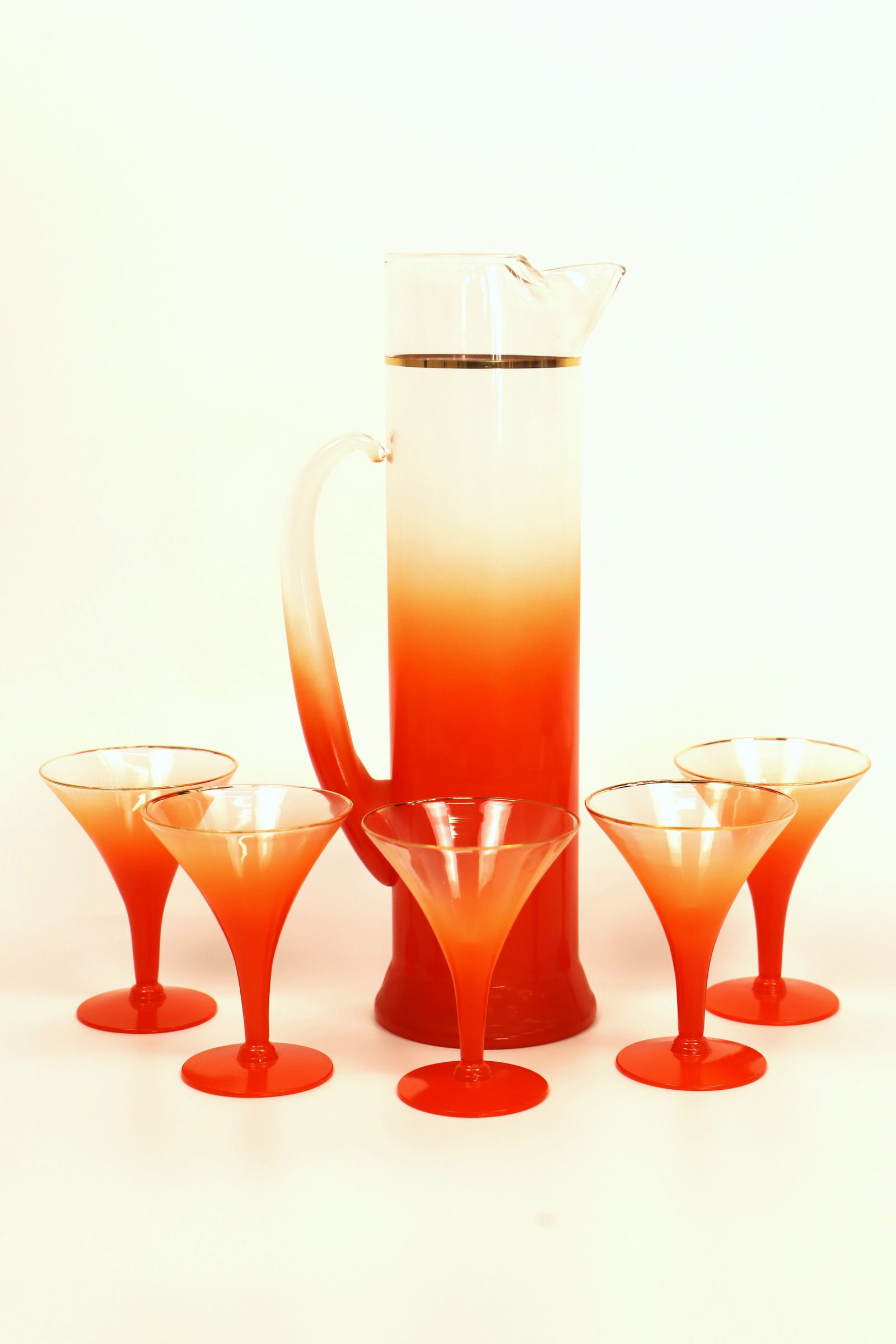 MCM Martini Set: Mid-Century Modern frosted martini pitcher with five matching glasses; Possibly Blendo; Pitcher measures approximately H 13 x W 5 1/2 x D 4 inches; No damage observed. See photos