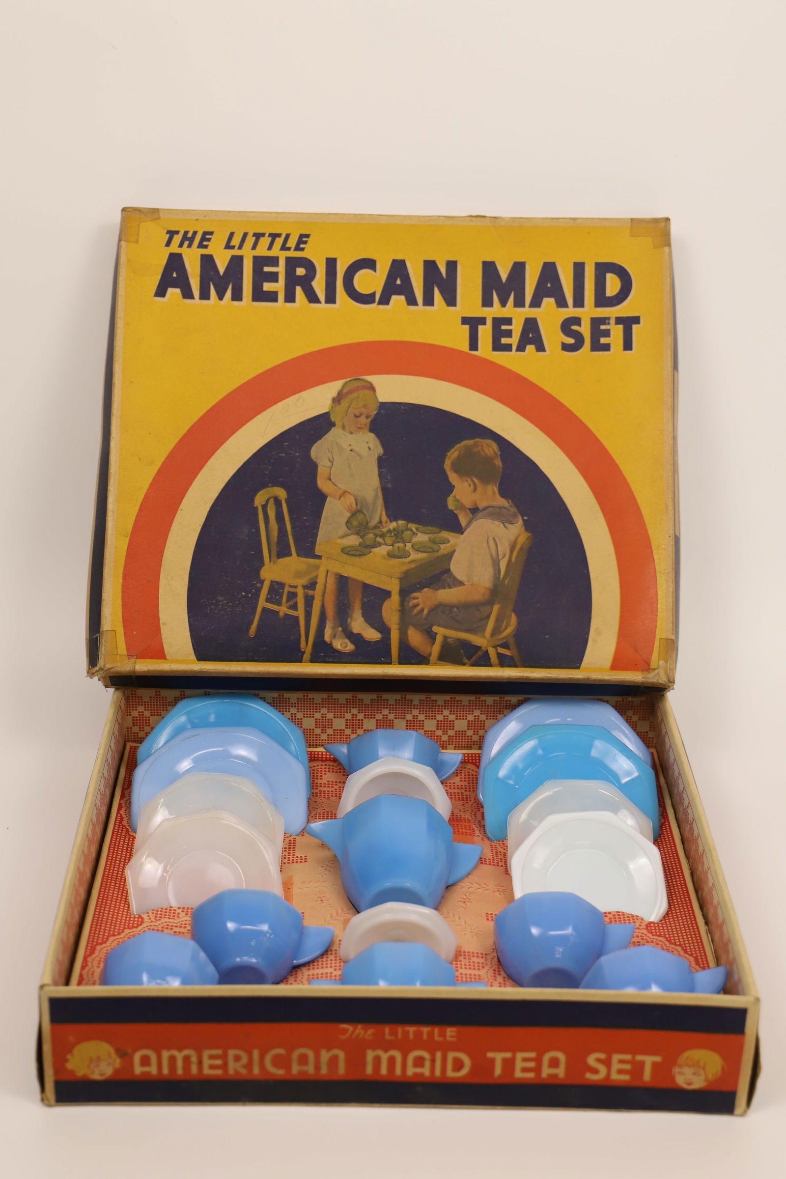 Akro Agate Co., Tea Set: Vintage "The Little American Maid Tea Set"; Number 335; In original box; Box measures approximately H 3 x W 14 1/2 x D 12 1/2 inches; Sugar lid is chipped; Box has been taped on all corners. See photo