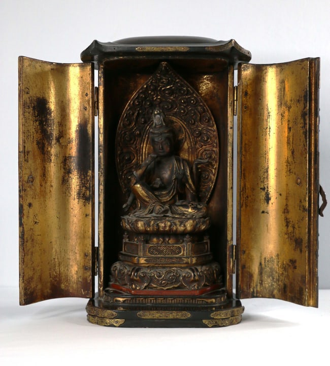 Japanese Shrine: Black lacquer box housing a Buddha; All wood construction with metal hinges and designs; Possibly late Meiji period; Measures approximately H 12 x W 7 x D 6 inches; Wear commensurate with age; See pho