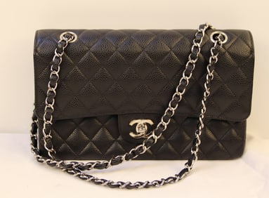 Chanel, Purse: Leather handbag by Chanel with dual chain handles; Quilted style exterior; Bag is black in color with silvertone leather and chain handles; Two cloth drawstring storage bags are included; Zippered poc