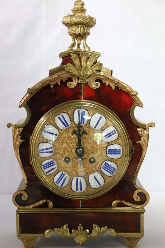 Vintage Mantel Clock: Possibly French clock; Constructed of wood and ormolu; Porcelain numbers with blue numerals; No maker marks observed; Measures approximately H 16 x W 9 x D 4 inches; Working condition unknown; Some me