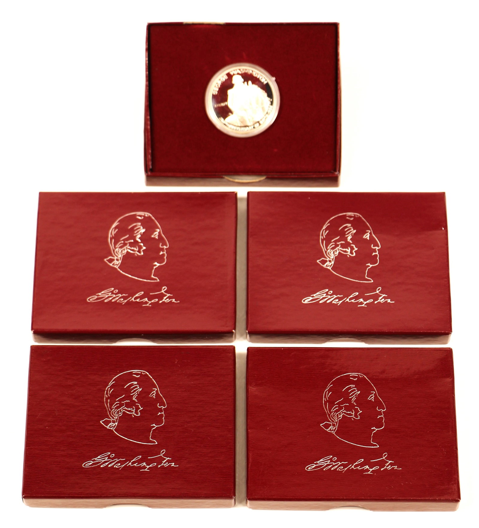 George Washington Commemorative Half Dollars: Five silver, George Washington's" half dollars; 250th anniversary commemorative coin; In presentation cases with documentation; 90% silver each. See photos