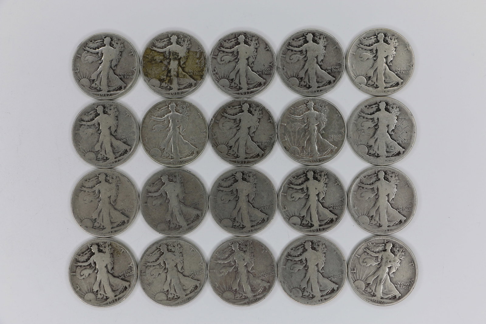 Walking Liberty Half Dollars: Twenty circulated, sterling silver, Walking LIberty fifty cent pieces; Dated from 1917 to 1944; Total weight is approximately 7.643 troy ounces. See photos
