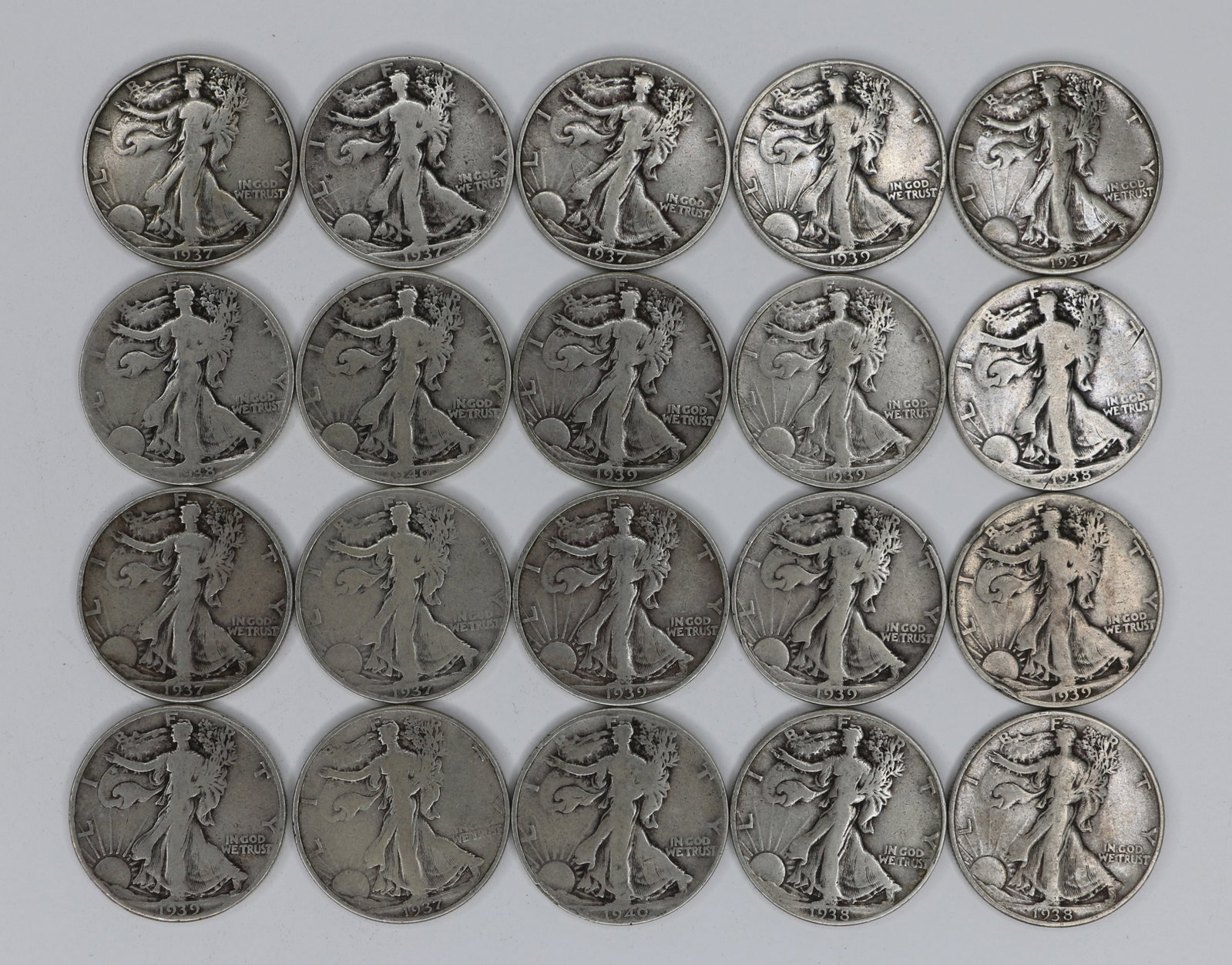Walking Liberty Half Dollars: Twenty circulated sterling silver Walking LIberty fifty cent pieces; Dated from 1937 to 1940; Total weight is approximately 7.825 troy ounces. See photos