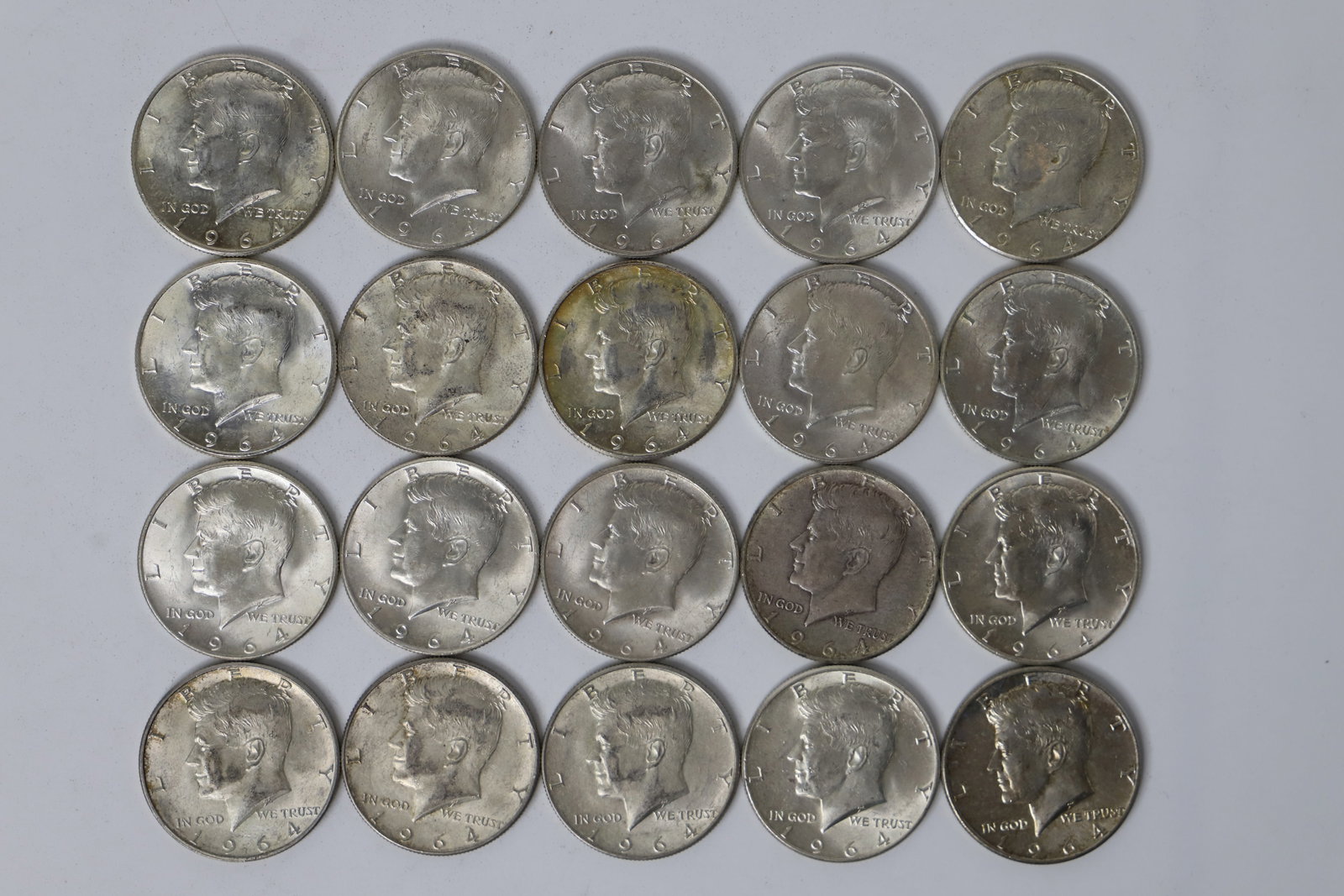 Kennedy Half Dollars: Twenty circulated, silver, Kennedy fifty cent coins; Dated 1964; Total weight is approximately 8.024 troy ounces. See photos