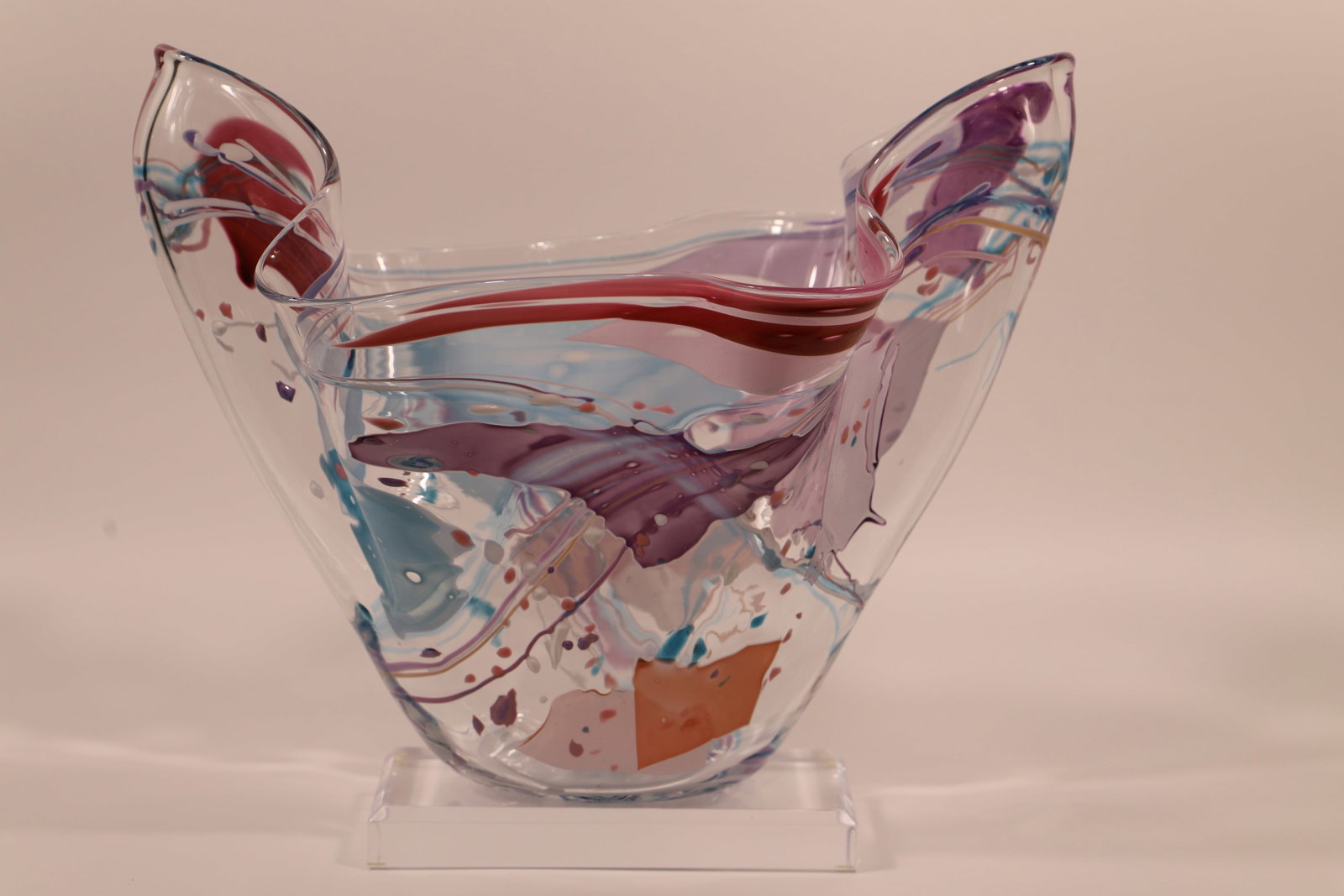 Stehen Rich Nelson, Vase: Artist signed art glass vase; Numbered 13094; Sits on an acrylic base; Measures approximately H 12 x W 15 x D 8 inches; No damage observed. See photos