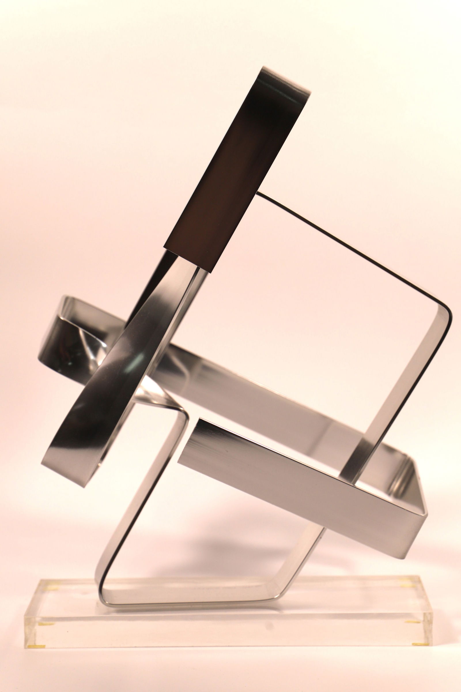 Dan Murphy, Sculpture: Metal art sculpture on acrylic base; Signed "copyright 1977 Dan Murphy"; Measures approximately H 17 x W 12 x D 6 1/2 inches; Scratches on the acrylic base. See photos