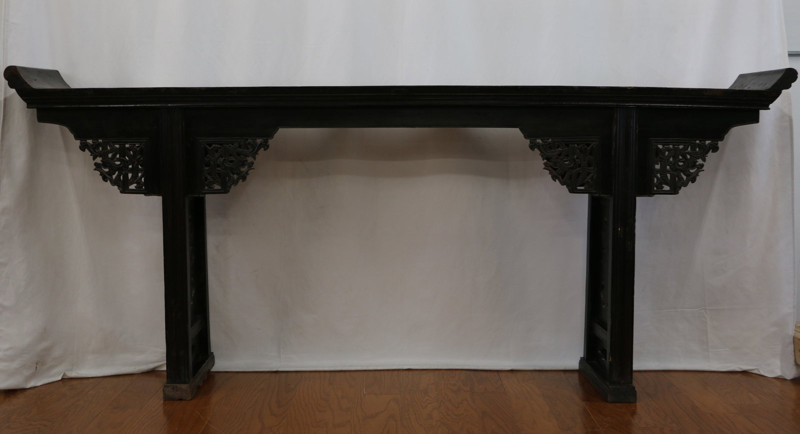 Antique Chinese Altar Console: Black lacquered finished wood console table with decorative scroll carvings; Wood top has rectangle shaped pegs; Attached label with Asian characters; Measures approximately H 39 1/2 x W 93 x D 15 inc