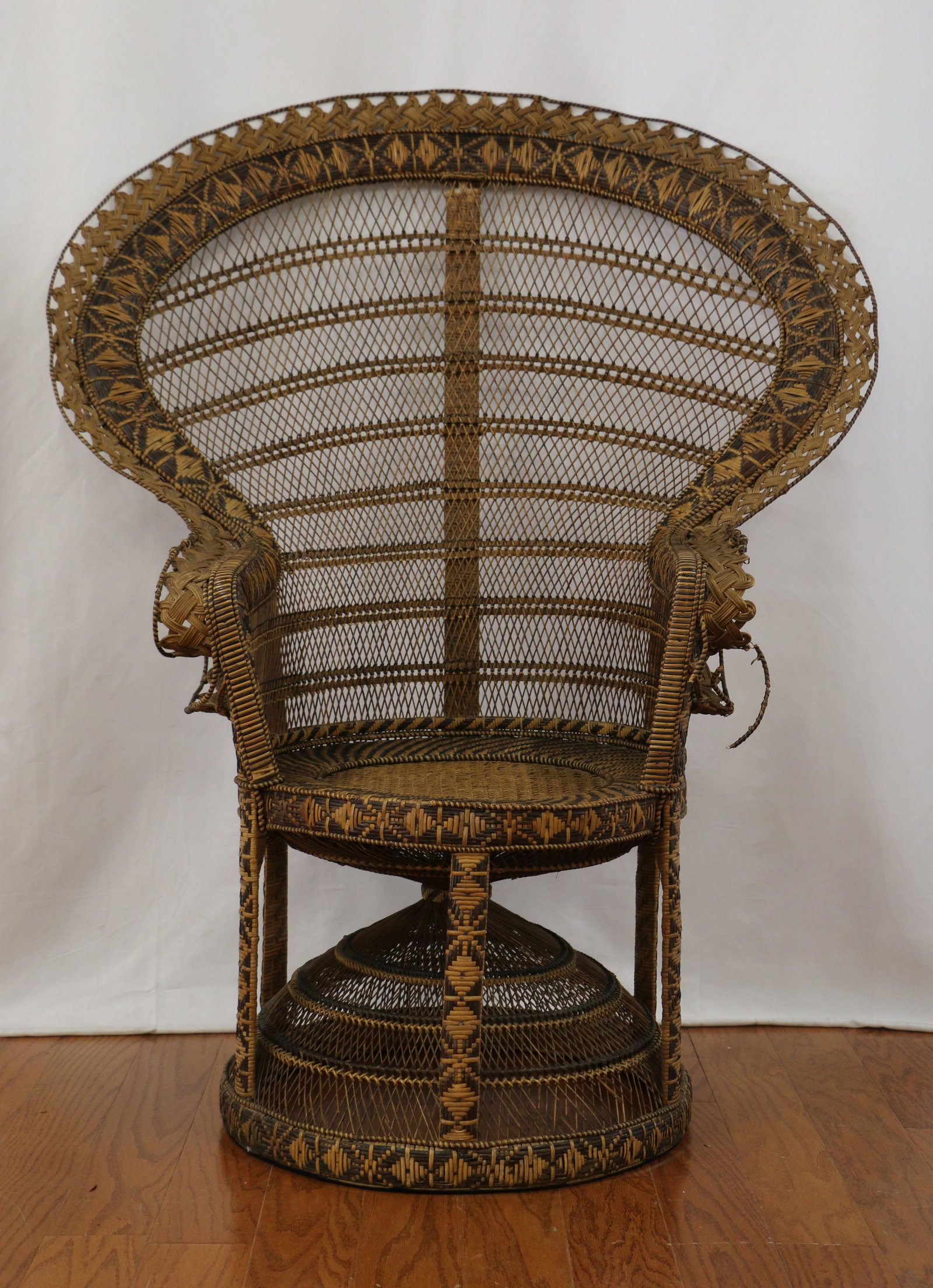 Antique Peacock Chair: Wicker peacock chair; Possibly made by Kok Maison; No maker marks observed; Measures approximately H 52 1/2 x W 42 1/2 x D 31 inches; Trim missing on front of seat; Wicker damaged on left arm, pieces