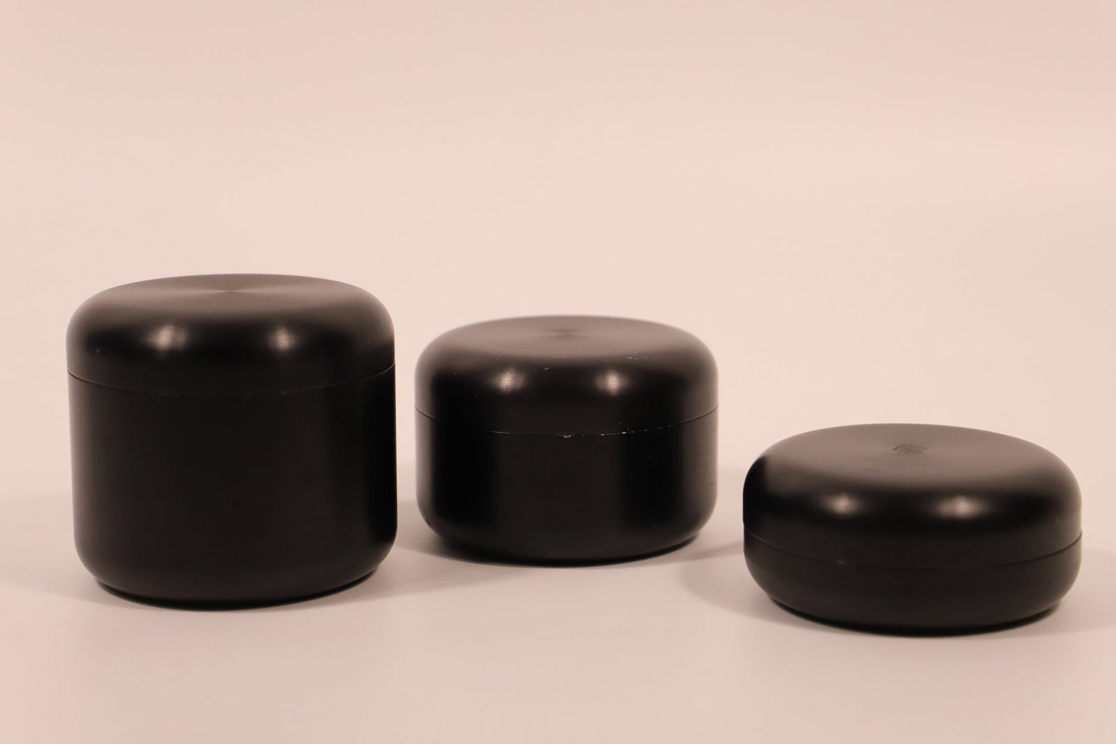 Georg Jensen, Black Storage Boxes: Three Georg Jensen Design, Denmark, metal boxes with lids; Largest measures approximately H 3 x Diameter 3 1/2 inches; Small chips and scratches on all pieces. See photos
