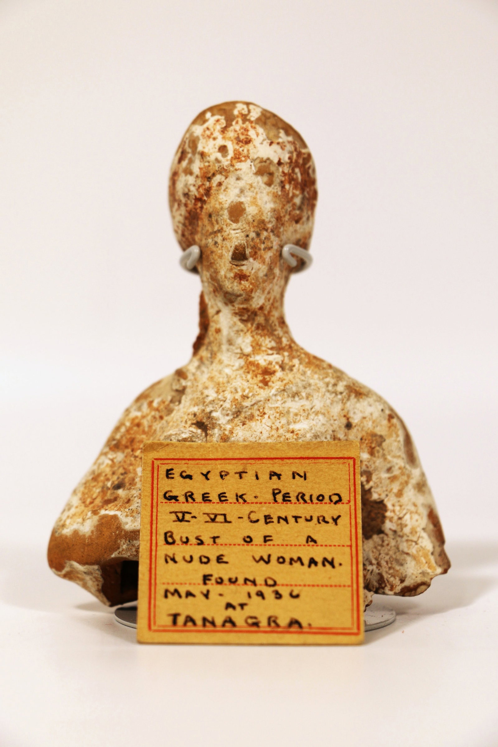 Antique Bust of Nude Women: Pottery bust; Attached note identifies it as V or VI century; Possibly Greek or Egyptian; Found at Tanagra; Measures approximately H 3 x W 2 3/4 x D 1 1/4 inches; Wear commensurate with age; Writing o