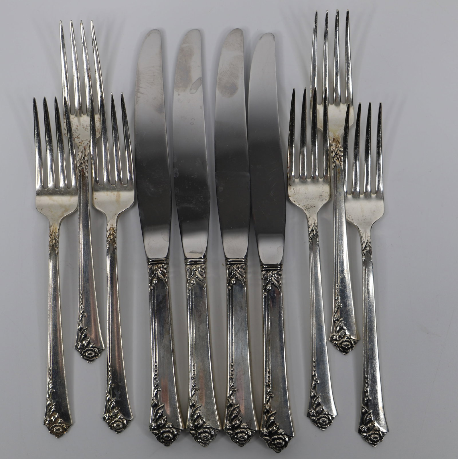 Heirloom, Sterling Silver Flatware: Six forks and four knives in the Damask Rose pattern; Forks weigh approximately 8.60 troy ounces; They are tarnished, dented and/or scratched. See photos