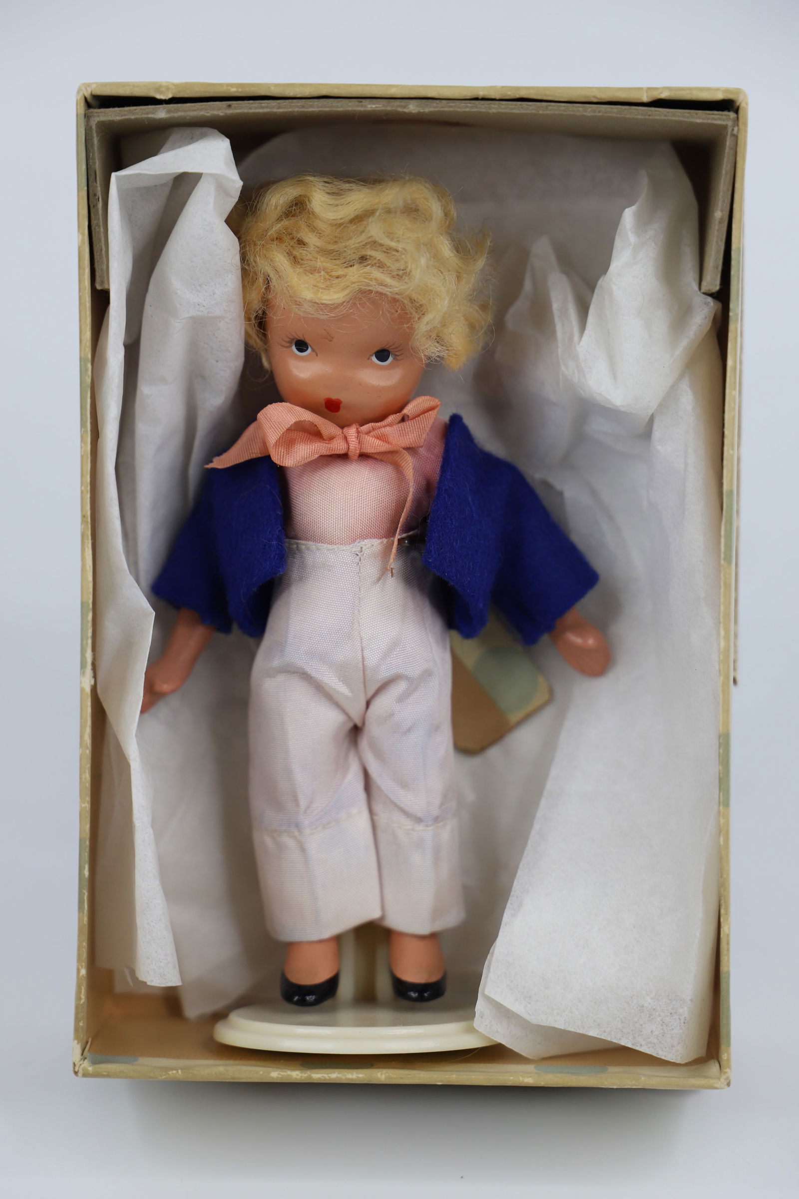 Nancy Ann Storybook Doll: "Little Boy Blue Come Blow your Horn"; Number 115; Bisque with stiff legs; Measures approximately H 5 1/4 inches; Box is damaged; No guarantee doll is in correct box. See photos