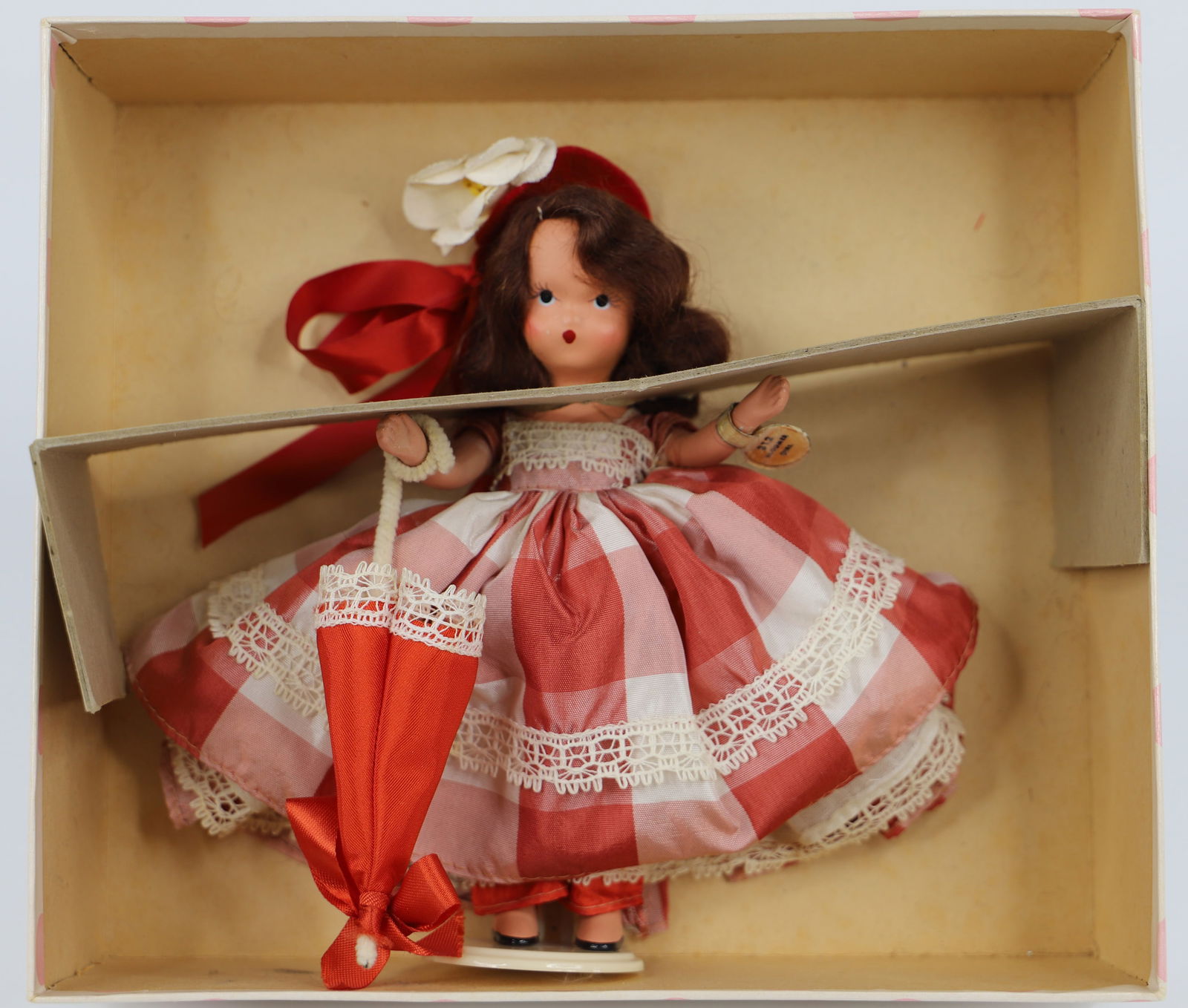 Nancy Ann Storybook Doll: Operetta Series "Bloomer Girl"; Number 312; Bisque with stiff legs; Gold label attached to left wrist; Measures approximately H 6 inches; Labels on box; No guarantee doll is in correct box. See photos
