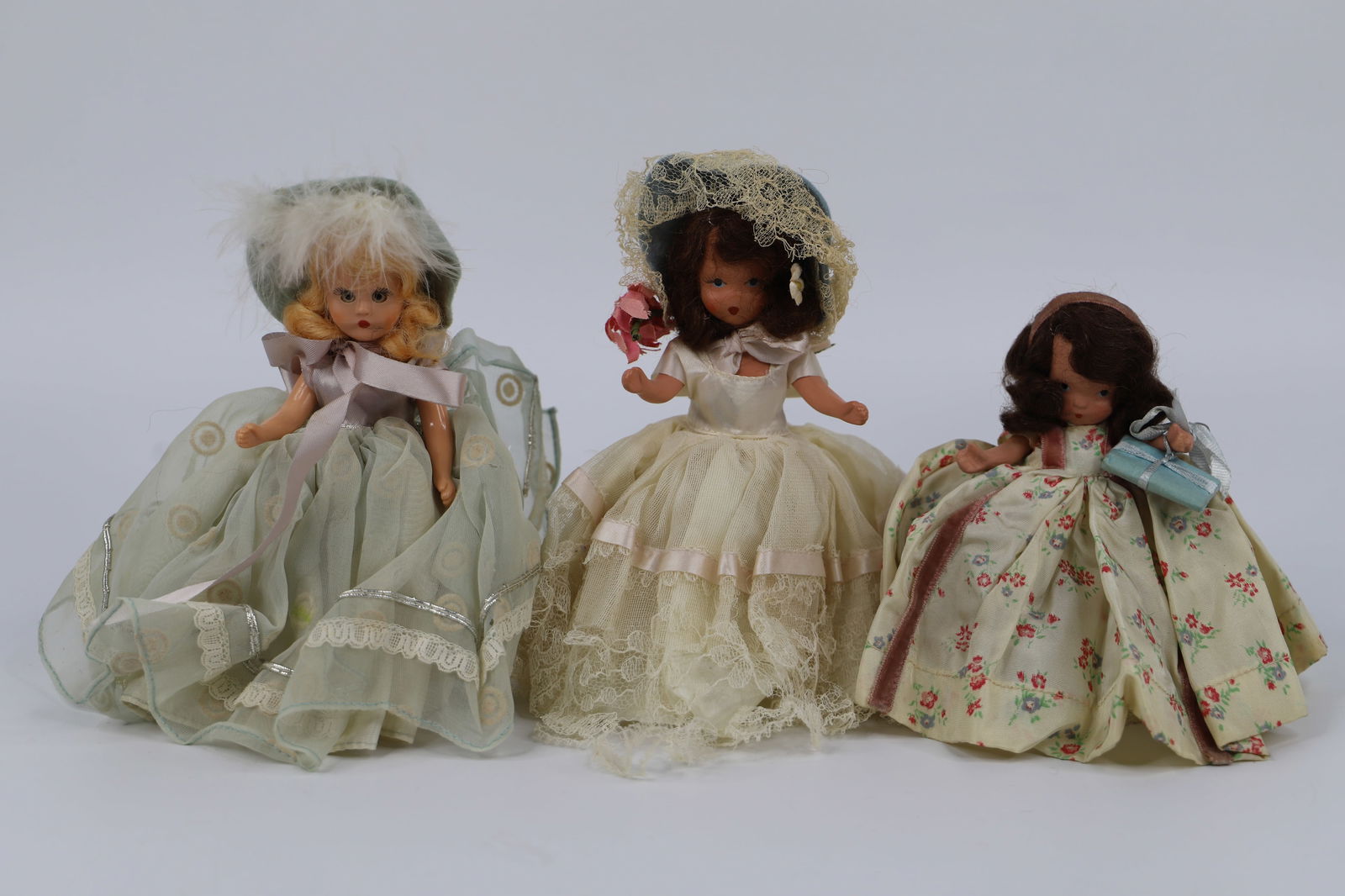 Nancy Ann Storybook Dolls: One plastic and two bisque dolls; Largest has stiff legs and is possibly "Friday's Child"; Smallest is possibly "In my Easter Bonnet"; She measures approximately H 5 inches; Stains on clothes; Wear co