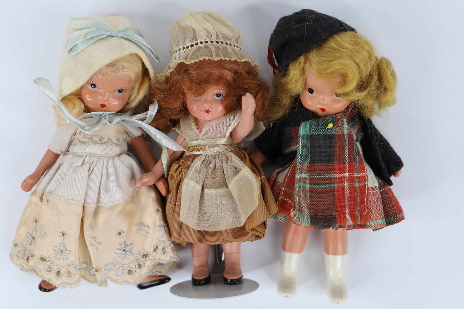 Nancy Ann Storybook Dolls: Two bisque Storybook dolls; One is possibly "Scotch"; Bisque doll marked "Japan"; All have jointed legs; Scotch doll measures approximately H 5 1/4 inches; Bisque is flaking; Wear commensurate with ag