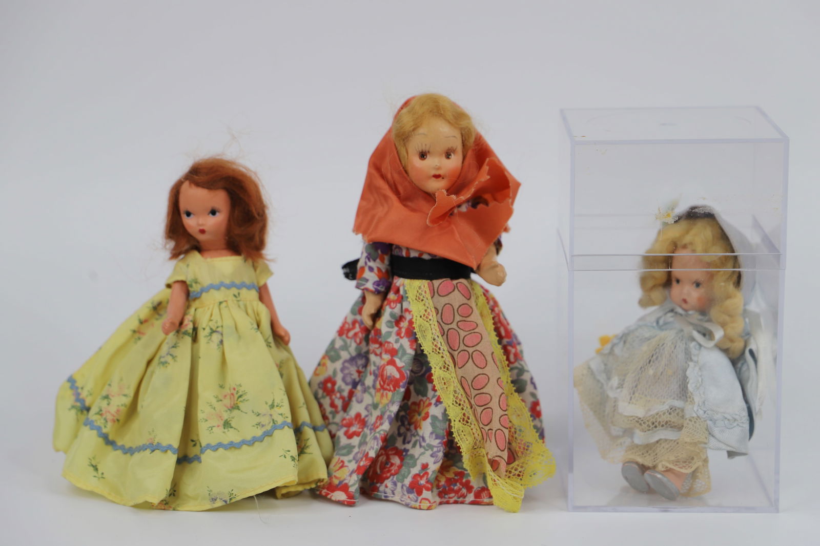 Nancy Ann Storybook Dolls: Three bisque, two with stiff legs; Smallest is possibly "Little Bo Peep" and is marked "Japan"; Doll with scarf has no visible marks; Yellow dress doll is marked "Storybook Dolls"; She measures approx